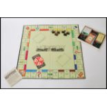 A vintage " Monopoly " board game by Waddingtons. War-time edition with wooden/card movers, black £