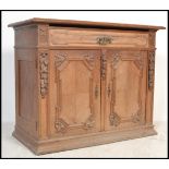 A 19th century oak french buffet de corps, sideboard with a fruit wood top and carved detailing to