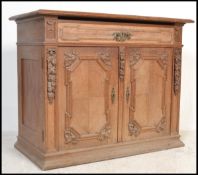 A 19th century oak french buffet de corps, sideboard with a fruit wood top and carved detailing to