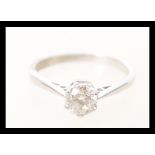 A stamped 750 18ct white gold diamond solitaire ring, prong set with a brilliant cut diamond.