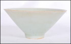 A believed antique Chinese Celadon glaze bowl of conical form raised on small circular foot.