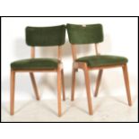 A pair of mid century retro blond wood dining chairs in the manner of Gordon Russell, Broadway. Each