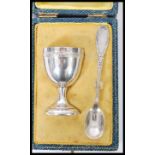 An early 20th century French silver egg cup and spoon bearing silver purity marks complete in