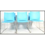 A set of six contemporary stacking dining chairs, moulded seat pads and back rests in one section,