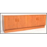 A retro 20th century G - Plan Fresco teak wood low sideboard having an arrangement of cupboards