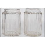 A pair of 19th century facet cut glass jars of cylindrical form having shaped necks believed to be