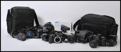 A collection of digital and vintage 35 mm cameras and lenses, to include a Nikon D40 and lens,