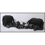 A collection of digital and vintage 35 mm cameras and lenses, to include a Nikon D40 and lens,