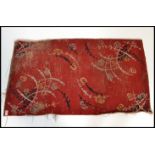 A hand woven Chinese / Tibetan rectangular floor rug having red ground  with decorative sprays of
