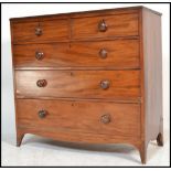 A George III 19th century mahogany chest of drawers being raised on kick legs with 2 short over 3