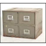 A 1920's Industrial metal 4 drawer filing cabinet having 4 drawers with pull handles and in the