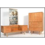 A vintage mid 20th Century light oak tallboy, two long doors over two drawers raised on shaped