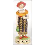 A late 18th / early 19th century Derby figurine of a lady flower picker with basket having a deep