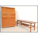 A 1970's Danish influence teak wood bureau together with a teak coffee table of rectangular form