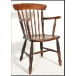 A 19th Century Victorian Windsor spindle back elbow armchair  / chair in beech and elm, raised on