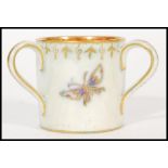 An early 20th century Wedgwood Fairyland Lustre three handles loving marriage cup depicting