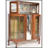 A vintage early 20th Century walnut glazed cocktail cabinet, the cabinet  having a central