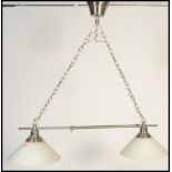 A pair of contemporary twin snooker table ceiling lights having two conical glass shades with chrome