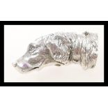 A silver vesta case in the form of a dogs head, having a hinged opening. Weight 42.2g.