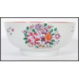 An 18th century Cantonese large Chinese ceramic bowl having hand painted floral sprays and famille