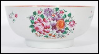 An 18th century Cantonese large Chinese ceramic bowl having hand painted floral sprays and famille