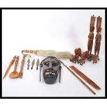 A collection of vintage 20th Century African tribal items to include a hard wood wall hanging face