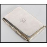 A large early 20th century silver hallmarked cigarette case of plain rectangular form having gilt