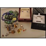 A selection of ladies jewellery to include a pair of stamped 18k gold stud earrings prong set with
