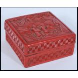 A 19th century Chinese Cinnabar Lacquer box of square form depicting scenes of elder and child