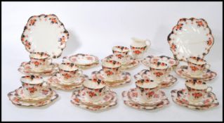 A 19th Century Victorian tea service by Paragon, in a blue and red Imari pattern having gilt rims