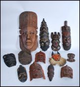 A collection of vintage wooden African tribal masks - wall hanging. To include hardwood and ebony