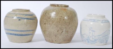 A group of three ginger jars to include to a bulbous from stoneware salt glazed jar, a similar jar