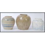 A group of three ginger jars to include to a bulbous from stoneware salt glazed jar, a similar jar