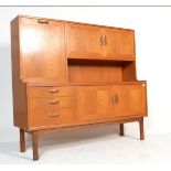 A 20th century vintage retro Sienna G-Plan highboard teak sideboard, raised on four turned legs,