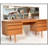 A vintage retro 20th Century teak wood kneehole dressing table, central recess flanked by two
