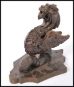 A 20th Century carved wood wall mount in the form of a mythical creature, dragon / griffin.