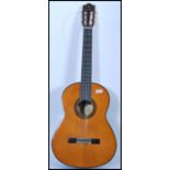 A vintage Yamaha G255 SII acoustic six string guitar having a shaped hollow body with mother of