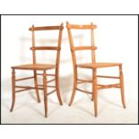 A pair of Victorian aesthetic movement bedroom chairs being raised on faux bamboo legs united by