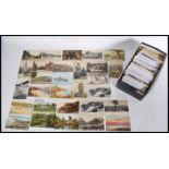 A shoe box of approximately 400 vintage postcards dating from the early 20th century to include