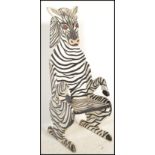 A vintage style child's nursery chair in the form of a zebra having tall picture back.