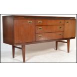 A vintage / retro 20th Century teak wood sideboard / credenza, central bank of three drawers flanked