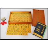 A vintage 20th century Mahjong gaming set, having 152 yellow plastic / Lucite pieces bearing