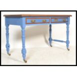 An early 20th century Edwardian painted mahogany writing table desk raised on turned and block