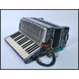 Musical Instruments: A vintage cased 20th Century Accordion, makers mark for La Regina Italia.
