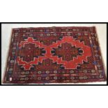 A vintage 20th Century Persian / Islamic woven woollen floor rug on blue ground decorated with