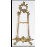A 19th century Victorian gilt brass table stand / wall mounted picture holder of scrolled form.