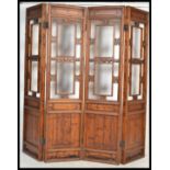 An early 20th Century Chinese four fold hardwood room divider, each section having carved open