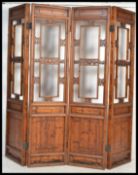 An early 20th Century Chinese four fold hardwood room divider, each section having carved open
