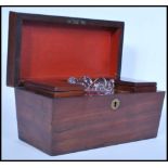 A 19th century mahogany tea caddy of sarcophagus form having a brass scutcheon to the front and a