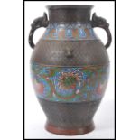 A early 20th Century oriental Chinese champleve bronze twin handled vase having enamelled panels